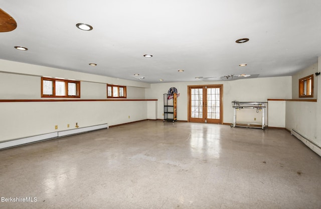 empty room featuring a baseboard heating unit, recessed lighting, french doors, and baseboards