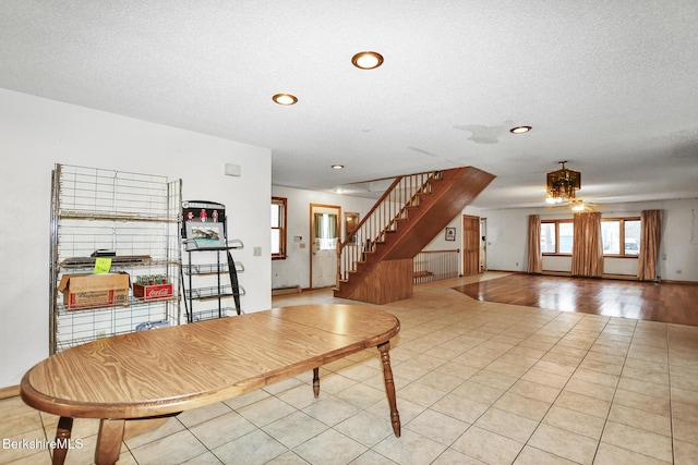 interior space featuring recessed lighting, stairway, a textured ceiling, and light tile patterned flooring