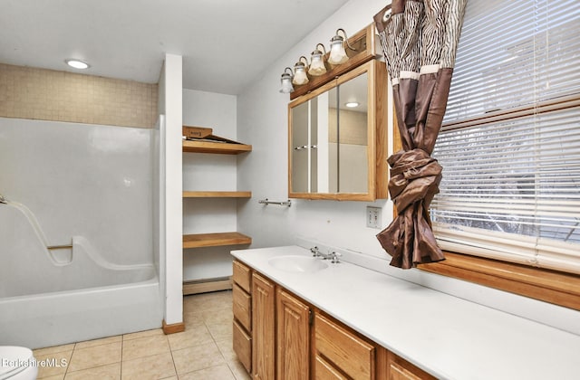 full bathroom featuring a baseboard heating unit, toilet, vanity, and tile patterned floors