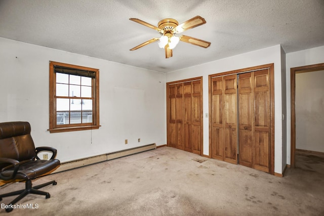 unfurnished room featuring light colored carpet, ceiling fan, a textured ceiling, and baseboards