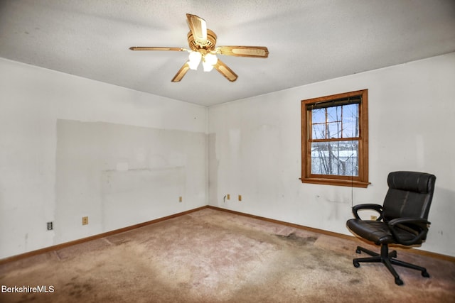 unfurnished room with a textured ceiling, carpet floors, a ceiling fan, and baseboards