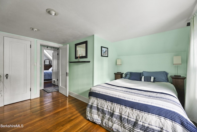 bedroom featuring dark hardwood / wood-style floors and lofted ceiling