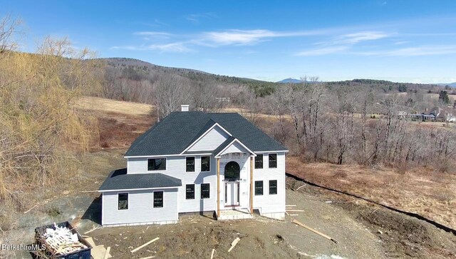 view of snow covered back of property