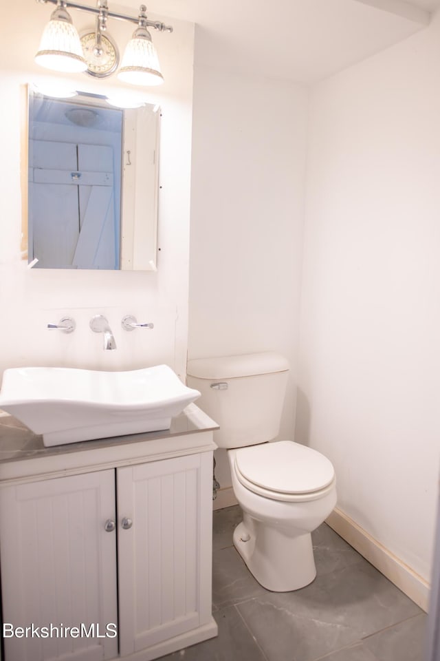207-209 Main St, Becket, MA 01223 - half bathroom with baseboards, toilet, and vanity