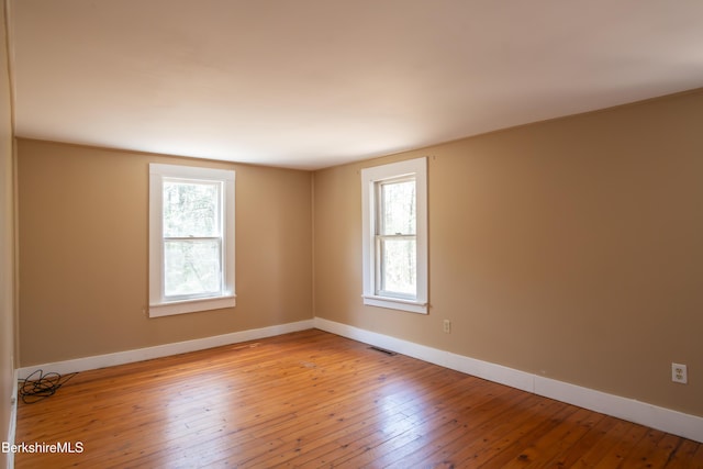 207-209 Main St, Becket, MA 01223 - empty room featuring visible vents, light wood-style flooring, baseboards, and plenty of natural light