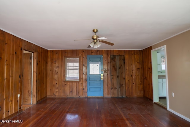 207-209 Main St, Becket, MA 01223 - unfurnished room with crown molding, wood-type flooring, baseboards, ceiling fan, and wooden walls