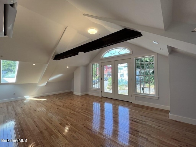 bonus room featuring french doors, lofted ceiling with beams, and wood-type flooring