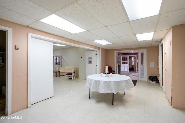 rec room featuring a paneled ceiling and french doors