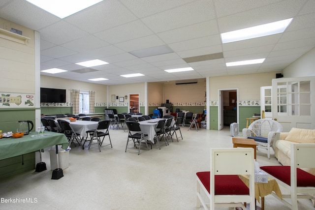 interior space with a paneled ceiling