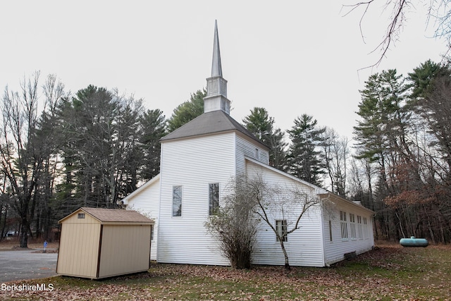 view of home's exterior with a storage unit