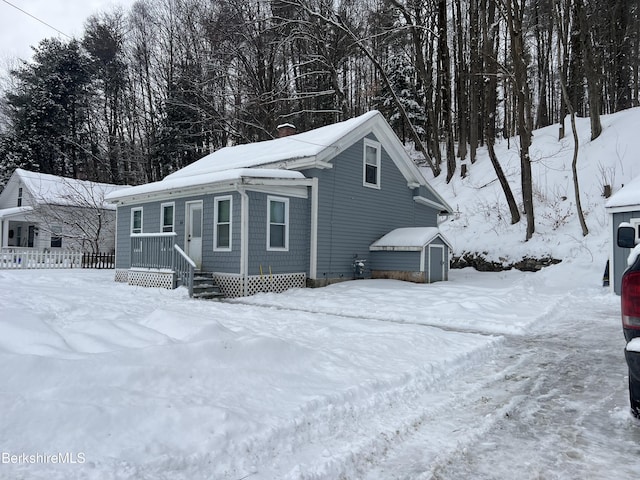 view of front of home featuring a shed