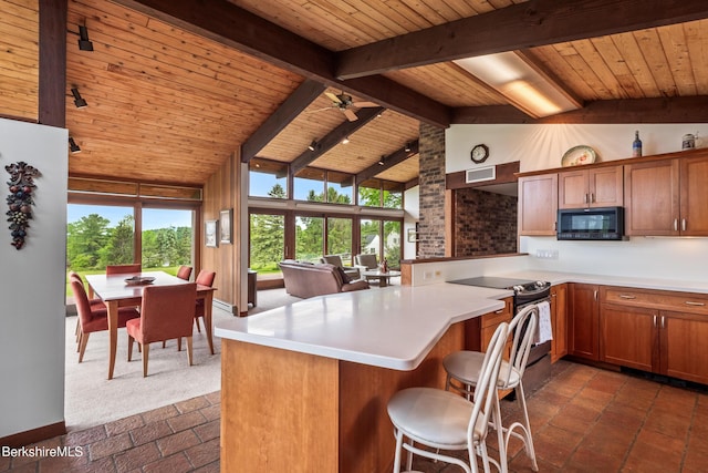 21 Kalliste Hl, Great Barrington, MA 01230 - kitchen with black microwave, wooden ceiling with exposed beams, brown cabinets, a peninsula, and light countertops