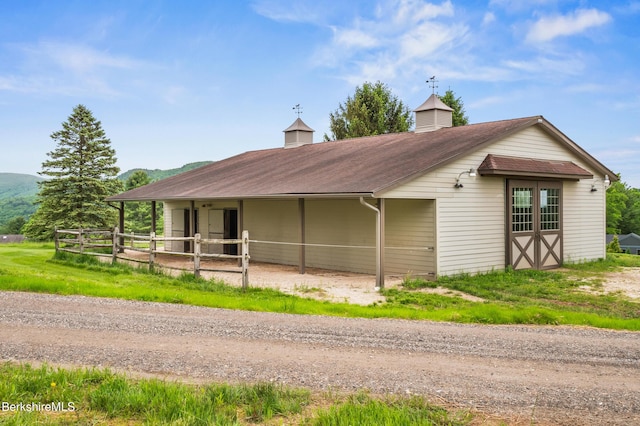 21 Kalliste Hl, Great Barrington, MA 01230 - view of front facade with an exterior structure, an outdoor structure, a mountain view, and a shingled roof