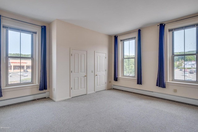 36 Holden St Unit A, North Adams, MA 01247 - unfurnished bedroom featuring a baseboard radiator, carpet floors, and multiple windows
