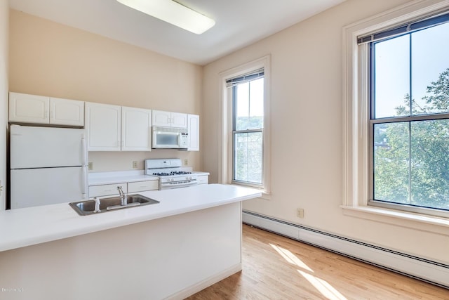 36 Holden St Unit A, North Adams, MA 01247 - kitchen with white appliances, a baseboard radiator, and plenty of natural light
