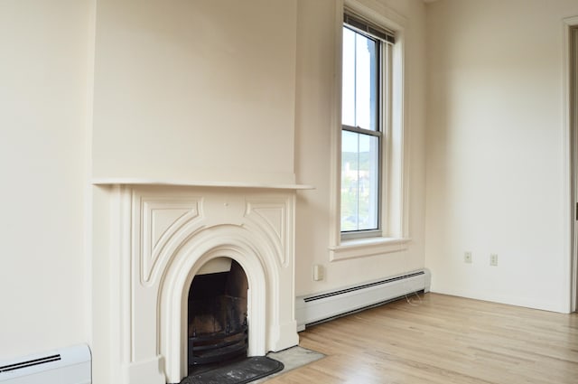 36 Holden St Unit A, North Adams, MA 01247 - detailed view of a baseboard radiator, a baseboard heating unit, and wood finished floors