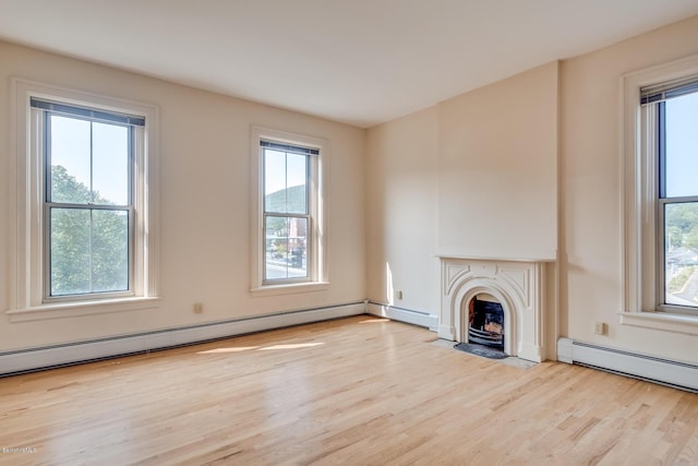 36 Holden St Unit A, North Adams, MA 01247 - unfurnished living room with wood finished floors, a fireplace with flush hearth, and baseboard heating