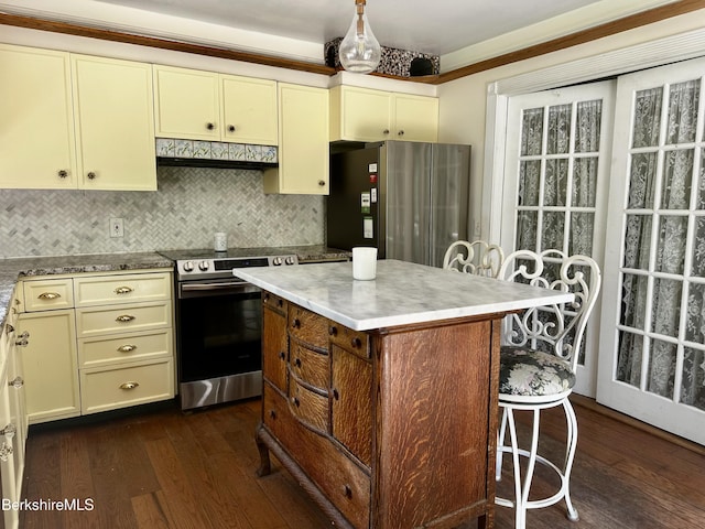 1689 E Windsor Rd, Windsor, MA 01270 - kitchen featuring stainless steel appliances, under cabinet range hood, cream cabinetry, and dark wood-style flooring