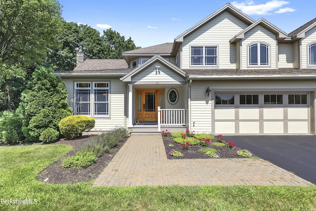 view of front facade featuring a porch and a garage