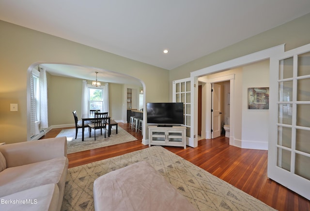 living room with wood-type flooring and a baseboard radiator