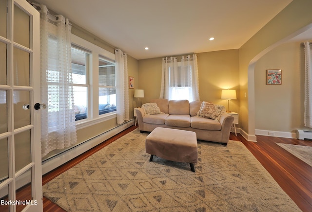 living room featuring a baseboard radiator and hardwood / wood-style flooring