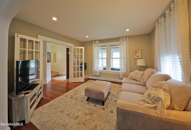 living room featuring french doors, dark wood-type flooring, and a baseboard heating unit