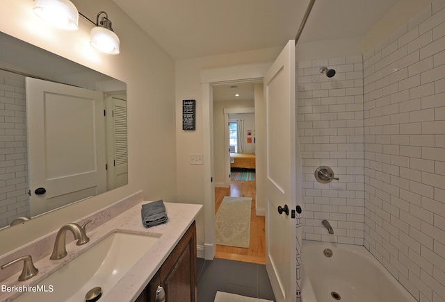 bathroom featuring vanity and tiled shower / bath combo