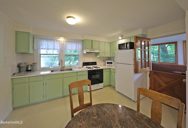 kitchen with white appliances, green cabinets, and sink