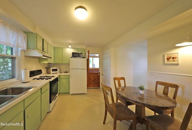 kitchen with sink, green cabinets, backsplash, white appliances, and ornamental molding