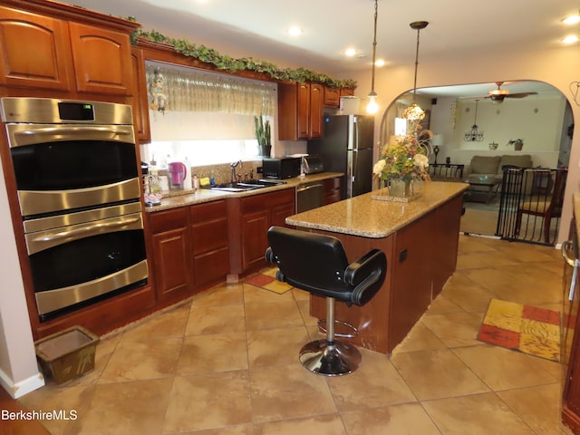 94 Gale Ave, Pittsfield, MA 01201 - kitchen with stainless steel appliances, a center island, decorative light fixtures, light stone countertops, and recessed lighting