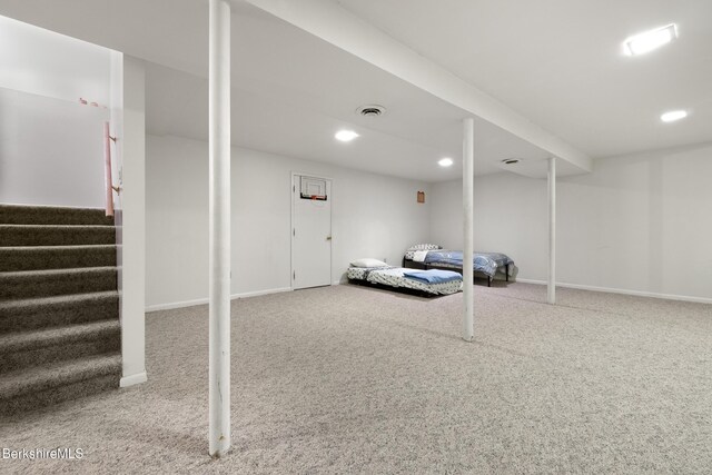 finished basement featuring carpet, recessed lighting, and stairs