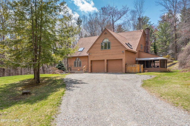 rustic home with a garage, a chimney, a front lawn, and gravel driveway