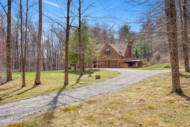 view of front facade with an attached garage, driveway, and a front lawn