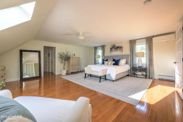 bedroom with a wall mounted air conditioner, lofted ceiling, a baseboard heating unit, hardwood / wood-style flooring, and ceiling fan