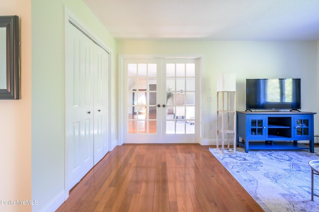 unfurnished living room with french doors and wood-type flooring