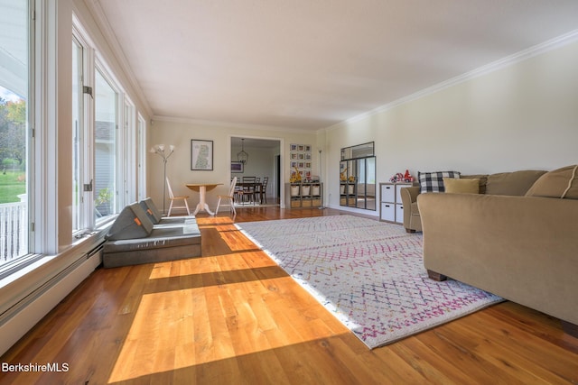 living room with hardwood / wood-style flooring, crown molding, and baseboard heating