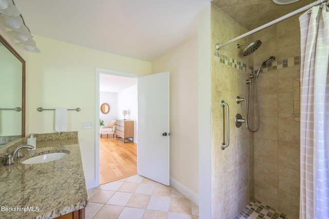 bathroom featuring tile patterned floors, vanity, and curtained shower