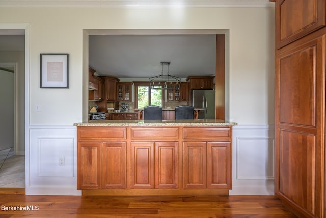 kitchen with stainless steel refrigerator, dark hardwood / wood-style flooring, and a chandelier