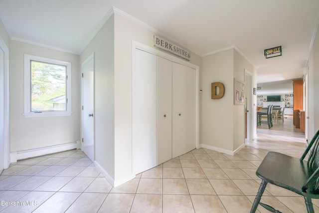 interior space with light tile patterned floors, ornamental molding, and a baseboard heating unit