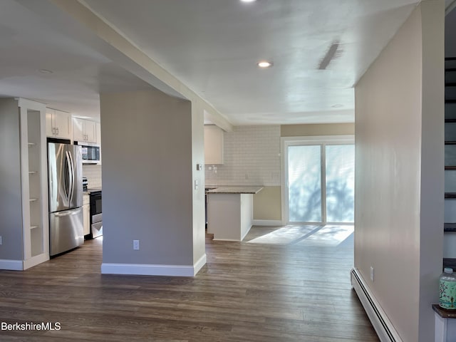 unfurnished living room featuring dark wood finished floors, baseboards, and baseboard heating