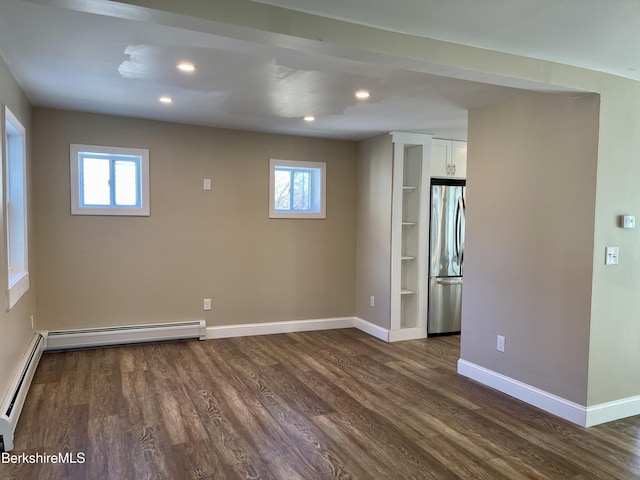 spare room featuring dark wood-style floors, baseboards, recessed lighting, a baseboard heating unit, and baseboard heating