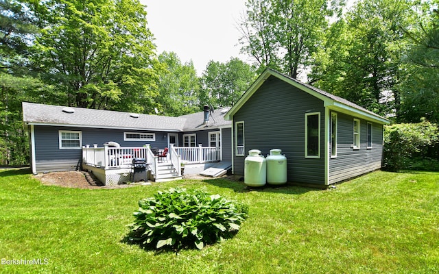 162 Ymca Rd, Becket, MA 01223 - back of property with a deck, a lawn, and view of wooded area