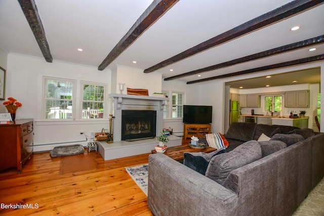 162 Ymca Rd, Becket, MA 01223 - living room with beamed ceiling, hardwood / wood-style flooring, a fireplace with raised hearth, a baseboard radiator, and recessed lighting