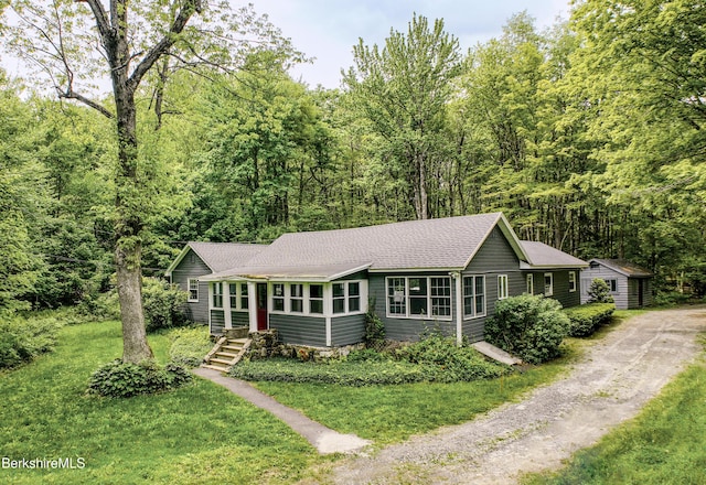 162 Ymca Rd, Becket, MA 01223 - ranch-style house featuring dirt driveway, a shingled roof, a forest view, and a front lawn