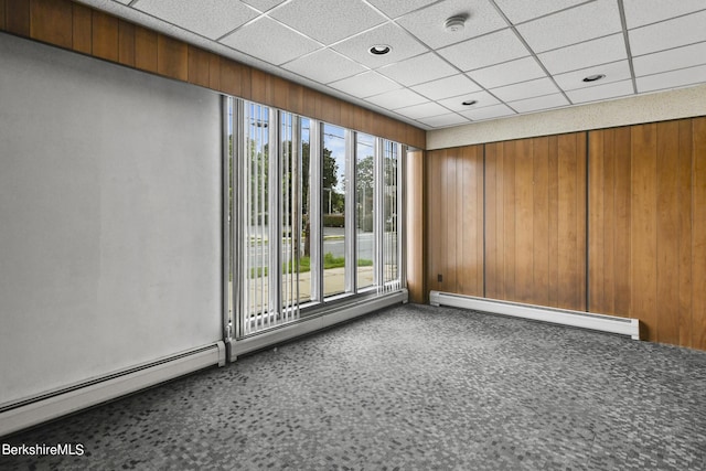 spare room with a baseboard radiator and a drop ceiling