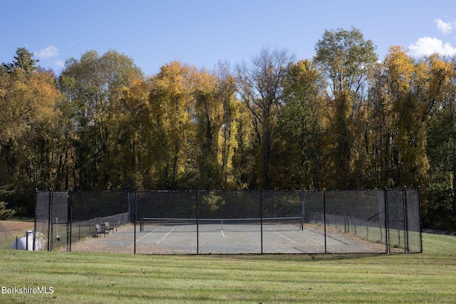 view of sport court featuring a lawn