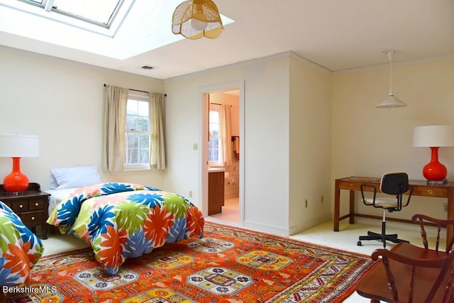 bedroom featuring a skylight, ensuite bathroom, and crown molding