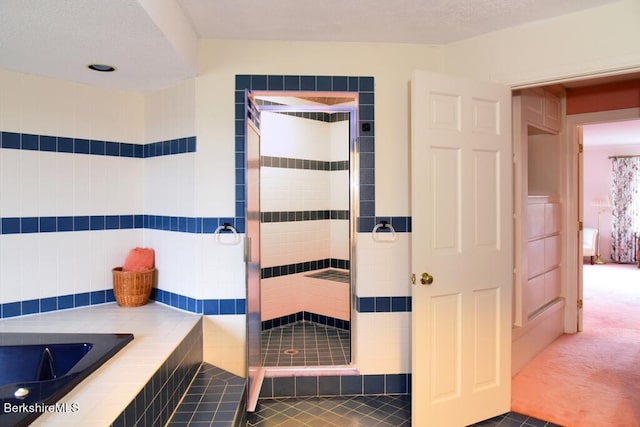 bathroom with tile patterned floors and separate shower and tub