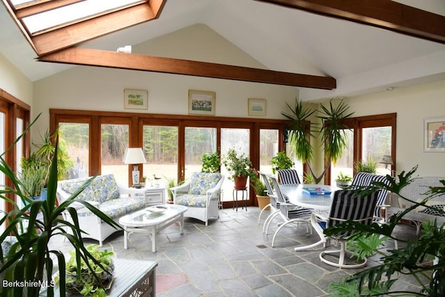 sunroom featuring vaulted ceiling with skylight