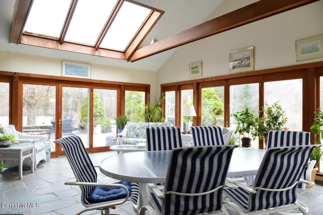 sunroom / solarium featuring lofted ceiling with skylight